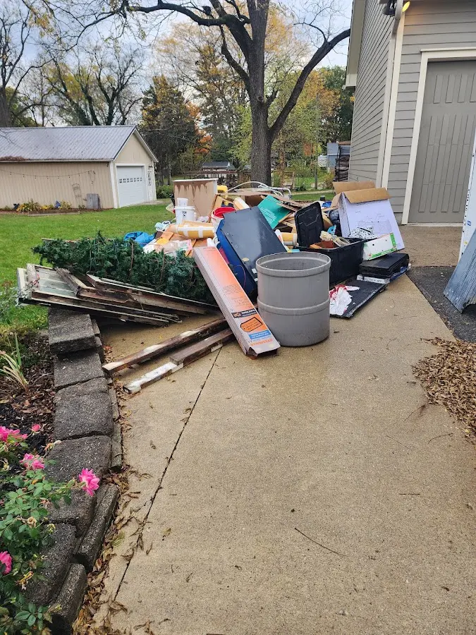 Dumpster being loaded with debris for Commercial Dumpster Rental in Eden